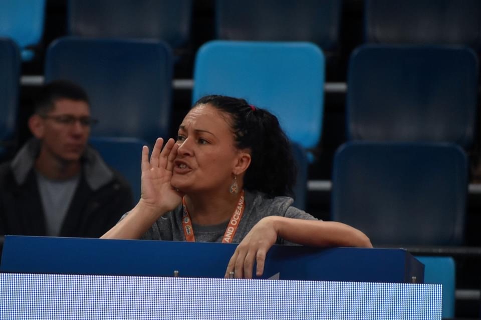 Sensei Carrie coaching intensely from the sidelines at an international judo competition